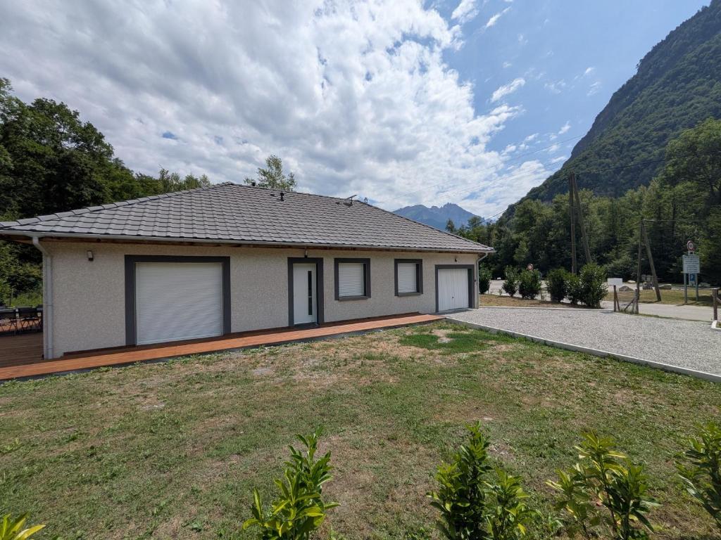 a house with a large yard in front of it at Maison vélo et ski in Saint-Jean-de-Maurienne