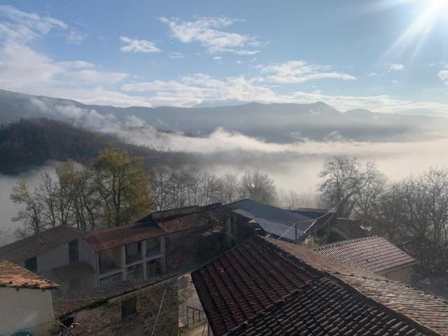 a view of a foggy valley with buildings and trees at Relais Borgo Poggetello in Tagliacozzo