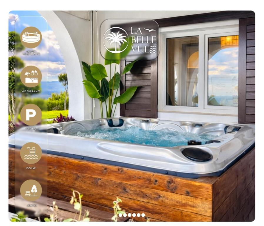 a bath tub in a bathroom with a window at La Belle Vue - Nouveau - Jacuzzi SPA Privé & Chauffé in Cabo Negro