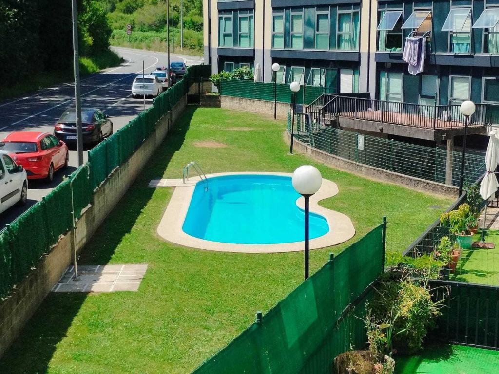a swimming pool in the middle of a yard at Confortable piso en Ares in Ares
