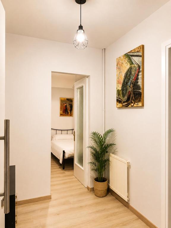 a room with a bed and a potted plant at Vathy Central Residence in Samos