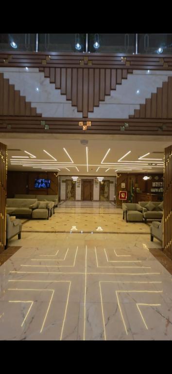 a large room with couches and tables in a building at فندق روشن كدي in Al Masfalah