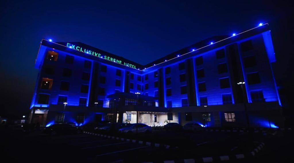 a building with blue lights on it at night at Exclusive Serene Hotel Abuja in Abuja