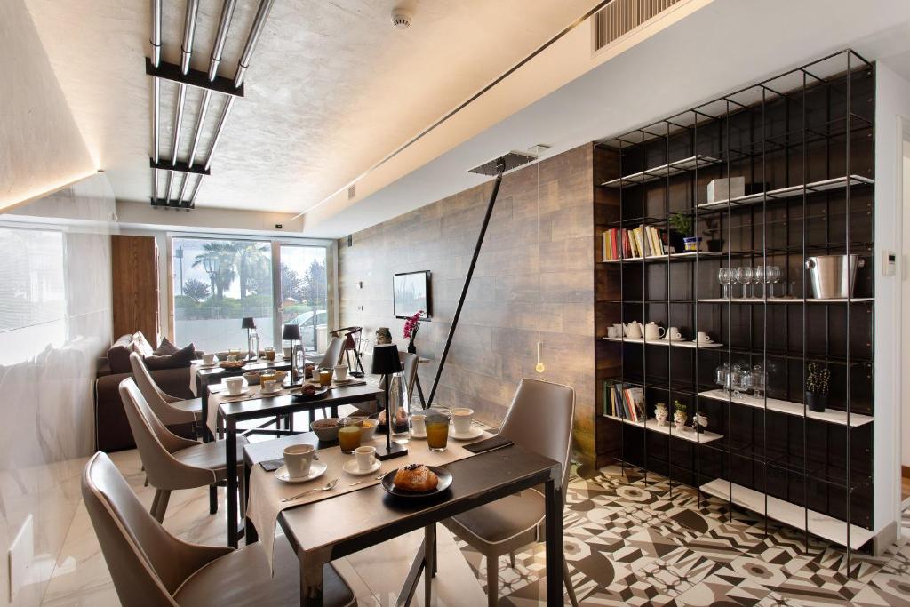 a restaurant with tables and chairs and a book shelf at Haddar Etna in Zafferana Etnea