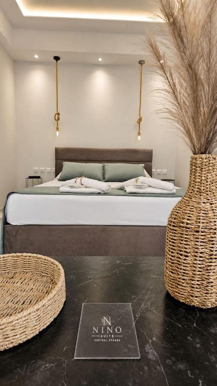 a bedroom with a bed with a sign on the floor at Nino Suite, Central Pyrgos in Pyrgos