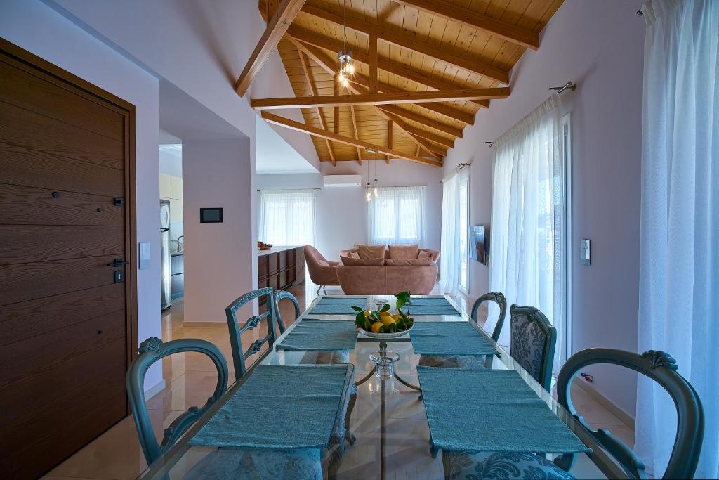 a dining room with a long table and chairs at Irida Home in Parga