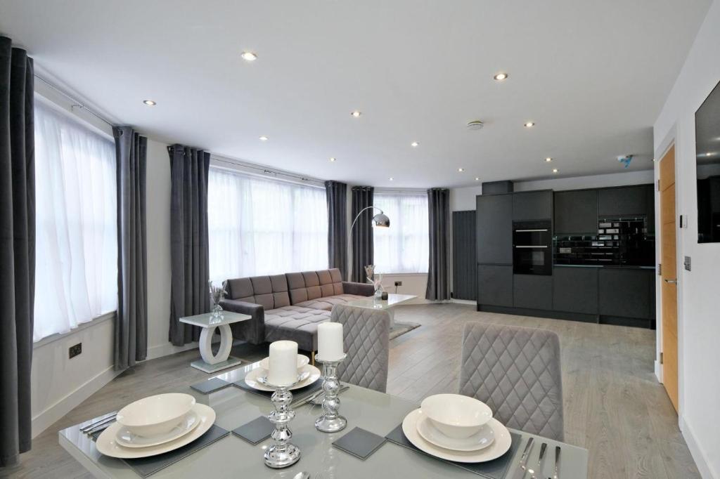 a kitchen and living room with a table and chairs at Kirkton House in Kirkton of Skene