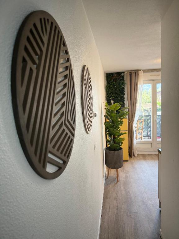 a mirror hanging on a wall in a room at Paisible studio fonctionnel in Cluses