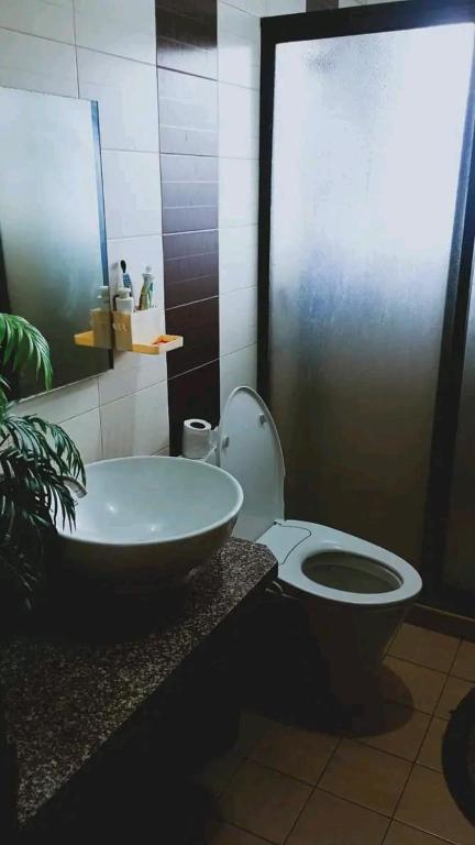 a bathroom with a toilet and a sink at Trip Nest Rentals in Dauis