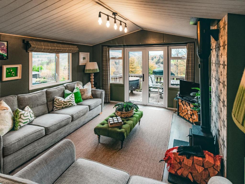 a living room with a couch and a tv at The Shepherd - Uk50613 in Sabden