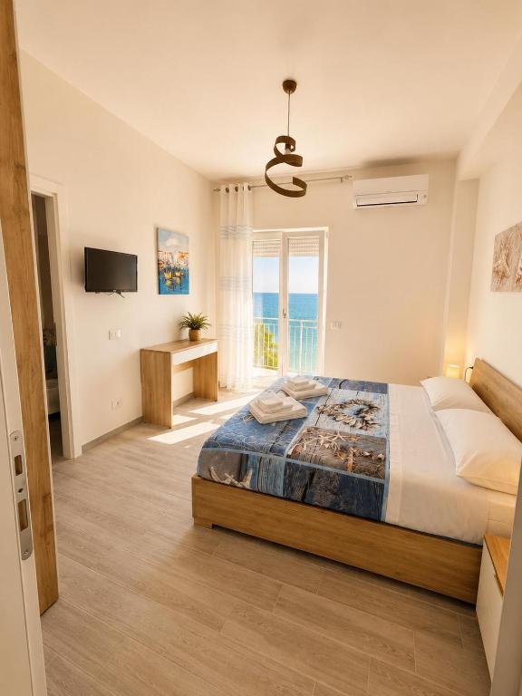 a bedroom with a bed and a large window at La Finestra Sul Mare in Torretta
