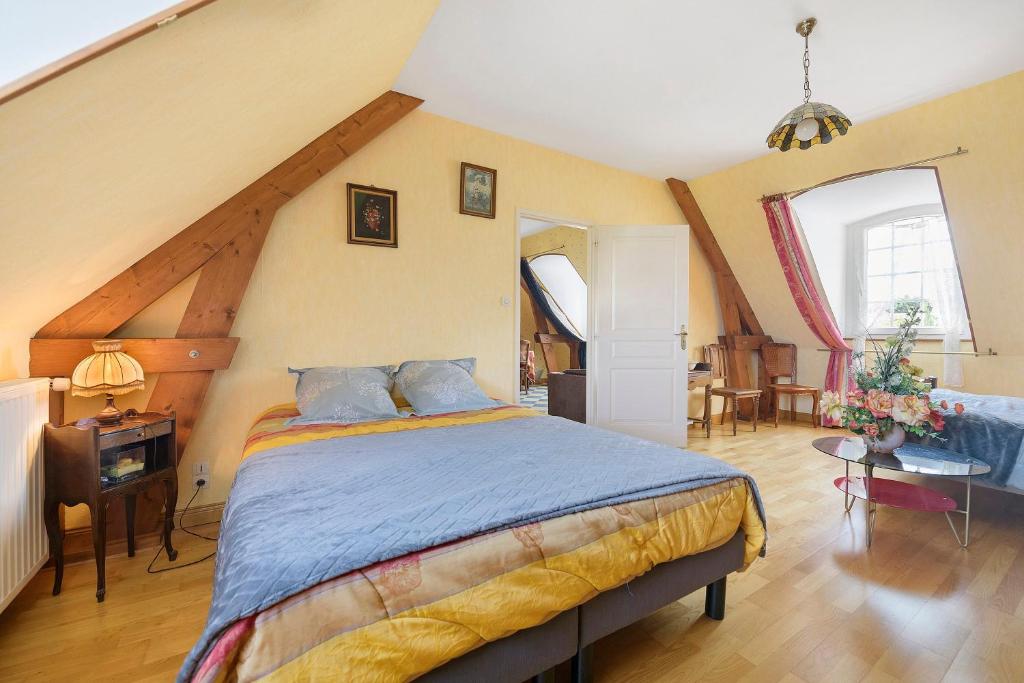a bedroom with a large bed in a attic at La tourelle de la croix in Picauville