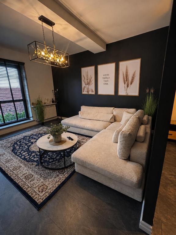 a living room with a couch and a table at Sleep Good by Adria 