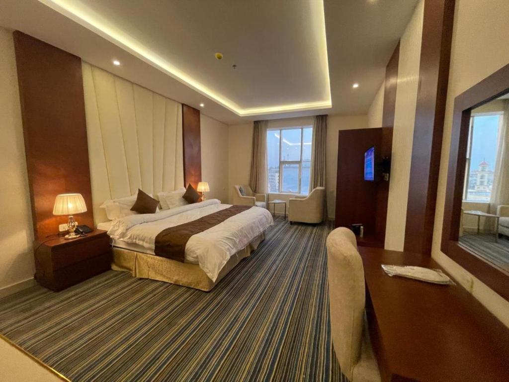 a large hotel room with a bed and a desk at نزل خيال جيزان in Jazan