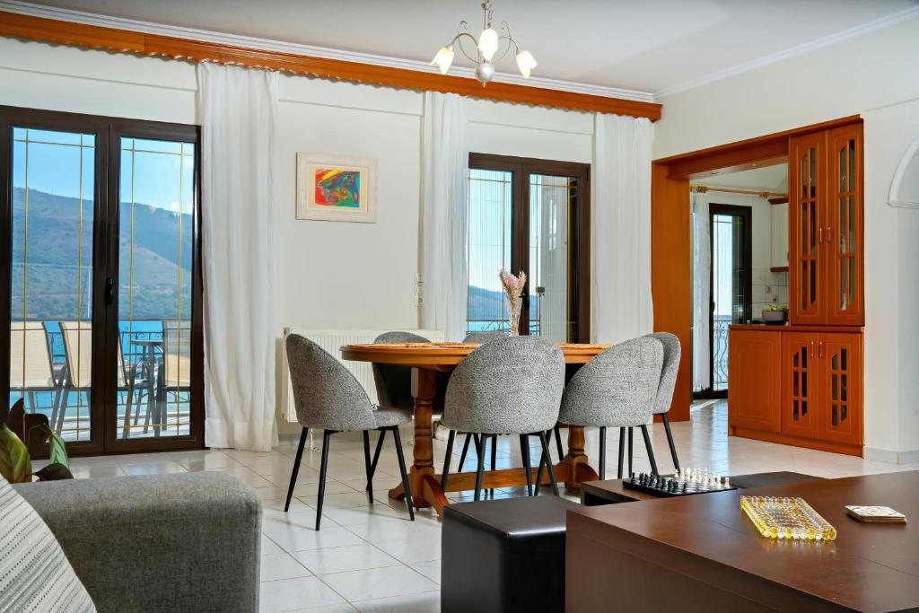 a living room with a dining room table and chairs at Vythos Occidens in Plataria