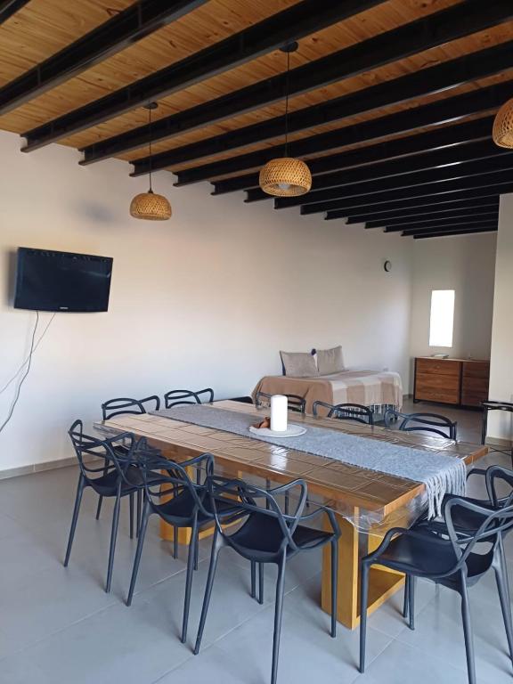 a dining room with a large wooden table and chairs at Quincho Lelita in Zonda
