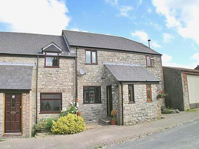 a large brick house on the side of a street at Eden Cottage in Cerne Abbas