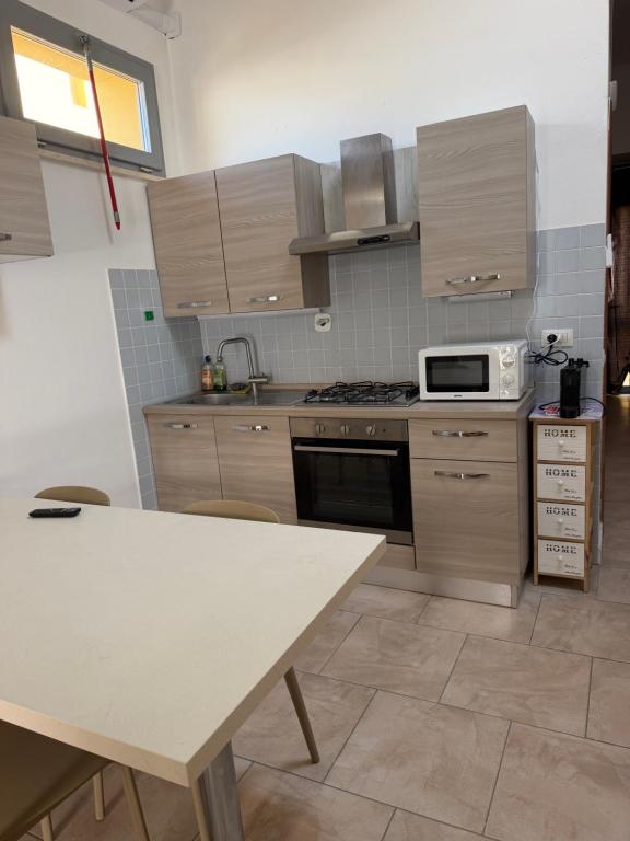 a kitchen with wooden cabinets and a white counter top at Casina Toscana in Certaldo