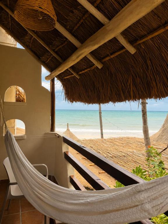 a hammock on a beach with a view of the ocean at Hotel Casa Colibri in Playa del Carmen