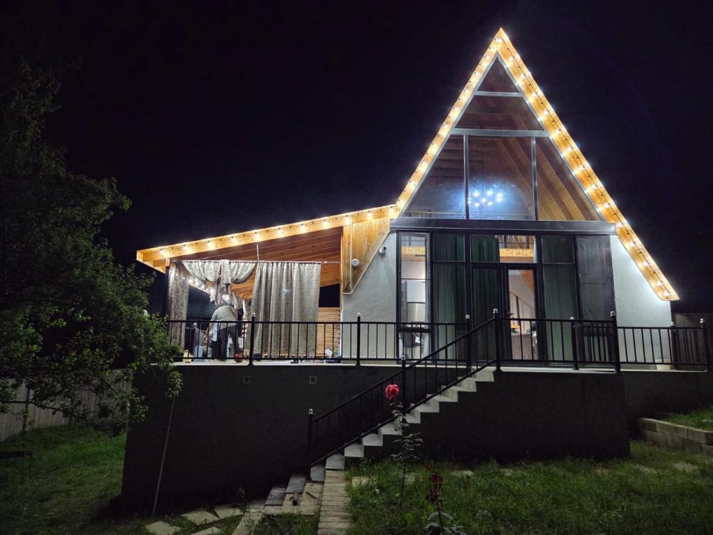 a house with lights on the roof at night at Villa ZM garden in Quba