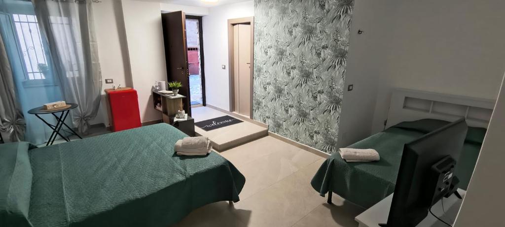 a hospital room with two beds and a mirror at B&B "Arberia"casa vacanze in San Giorgio Albanese