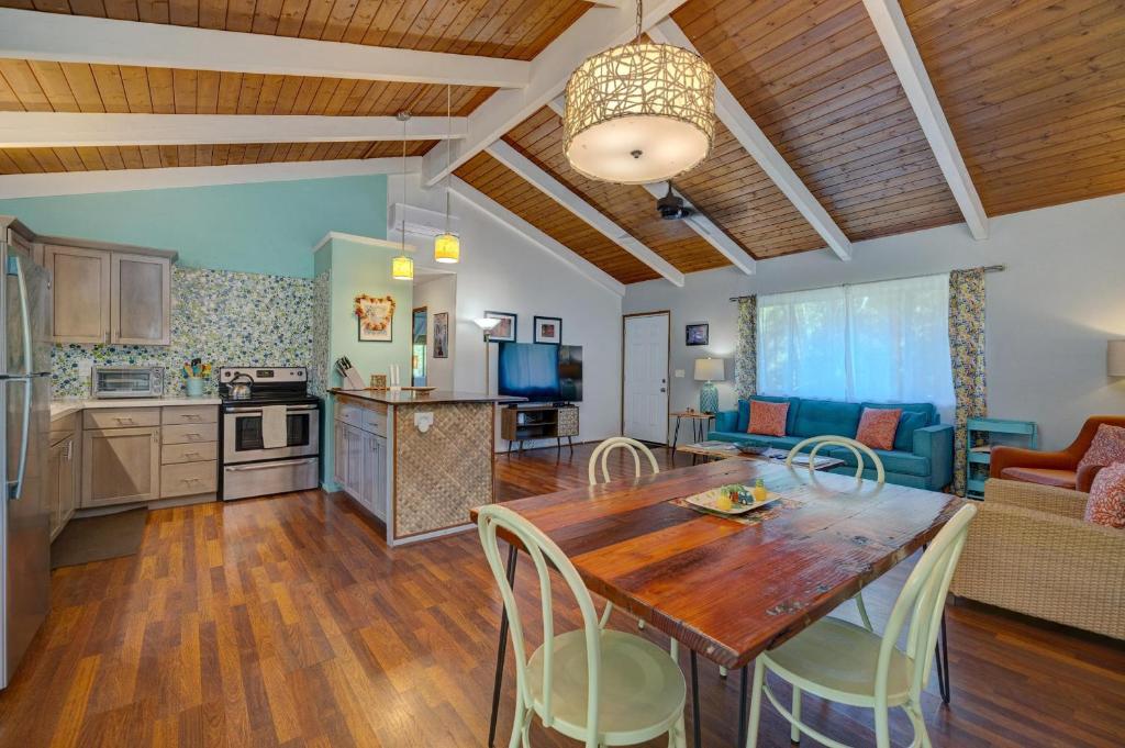 a kitchen and living room with a wooden table and chairs at Hale Ola Aina in Keaau