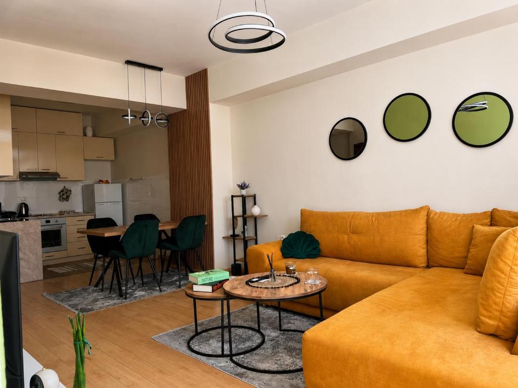 a living room with a couch and a table at Urban Taft Stay Skopje-Modern Vodno View Suite with Private Parking in Taftalidze in Skopje