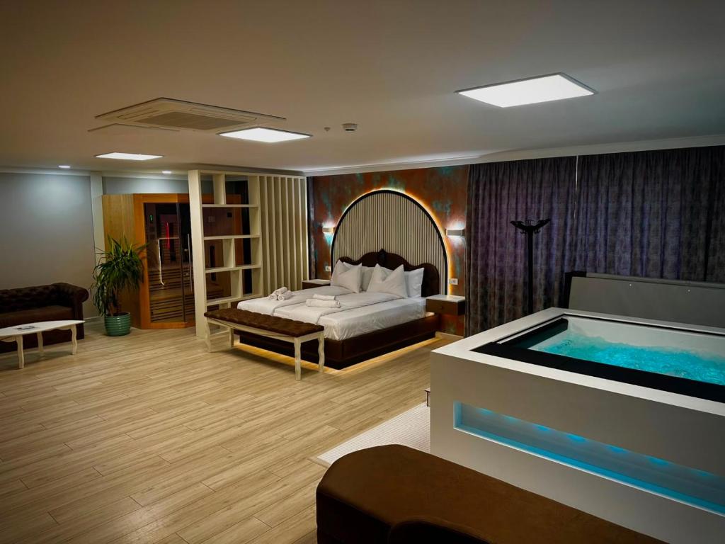 a bedroom with a bed and a swimming pool at Hotel Zouk Suite Spa in Alba Iulia