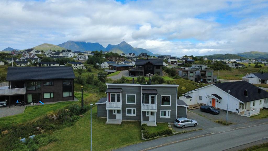 a town with houses and a street with a car at Cozy Lofoten Hideaway in Leknes