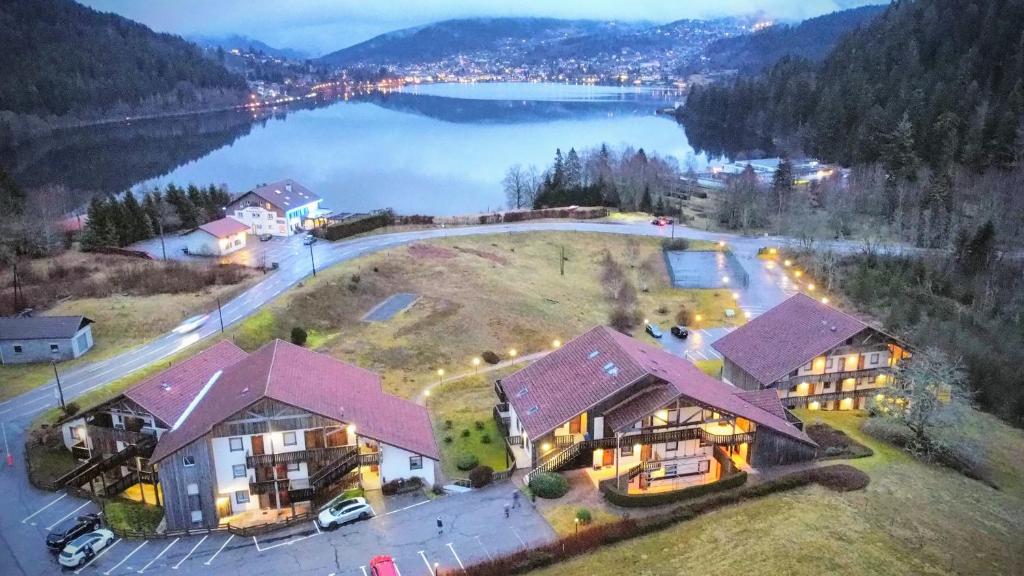 an aerial view of a house with a lake at Les Fermes du Lac - Appt 10A in Gérardmer