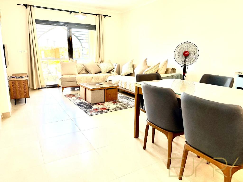 a living room with a couch and a table at Gaia 2BR First Floor Apartment in El Dab‘a