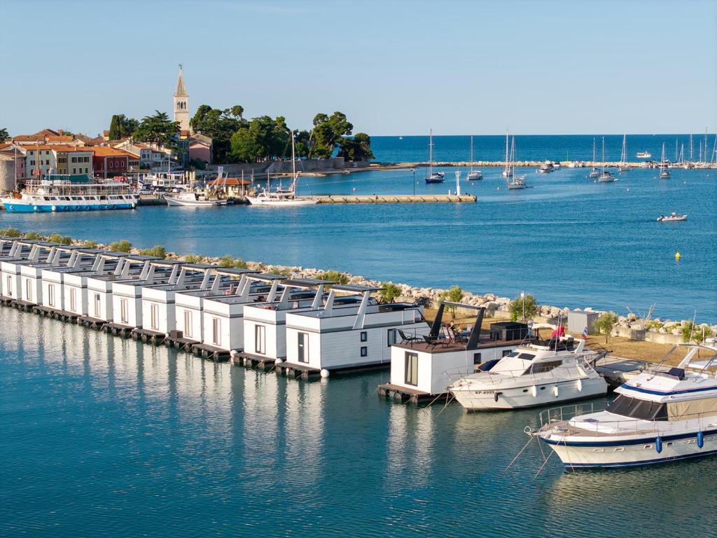 a group of boats docked at a dock in the water at Pearl Infinity Luxury Floating House in Novigrad Istria