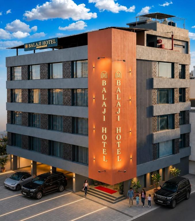a rendering of a hotel with cars parked in front at Balaji Hotel in Somnath