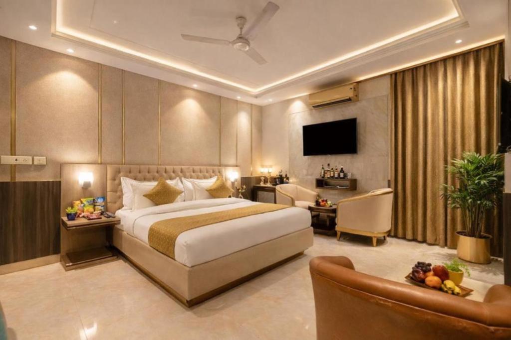 a hotel room with a large bed and a couch at Airport Vistara Cove By Velocity Group Terminal 2,3 Delhi IGI Airport With free Airport Pickup in New Delhi