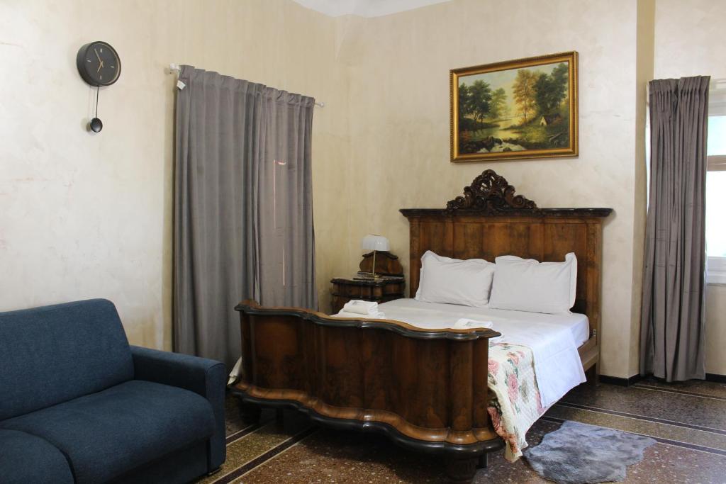 a bedroom with a bed and a couch and a chair at Genova Antica in Genoa
