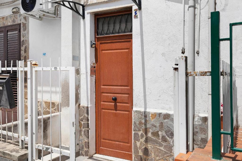 a wooden door on the side of a building at The Nice Bright House in Palermo
