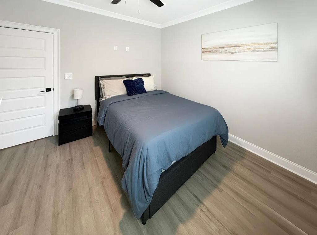 a bedroom with a bed with a blue comforter at Charlotte NC in Charlotte