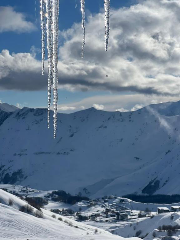 a bunch of icicles hanging in the snow at Loft New Gudauri LT in Gudauri