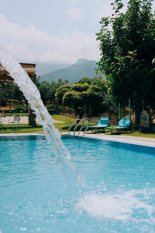 a water fountain in a swimming pool at Zeusplace Anamesa Pool Villa in Litochoro