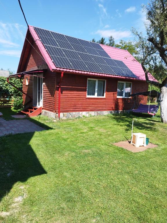 a house with solar panels on the roof at Casa Hirta in Ocna Şugatag