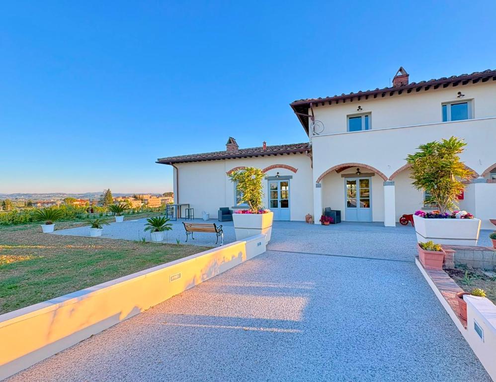 a house with a pathway leading to the front yard at Oliveta del Tabernacolo in Malmantile
