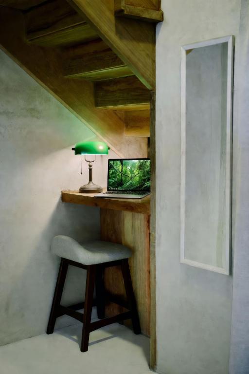 a desk with a chair and a laptop in a room at Beyond Alma Del Rio in Cristo Rey