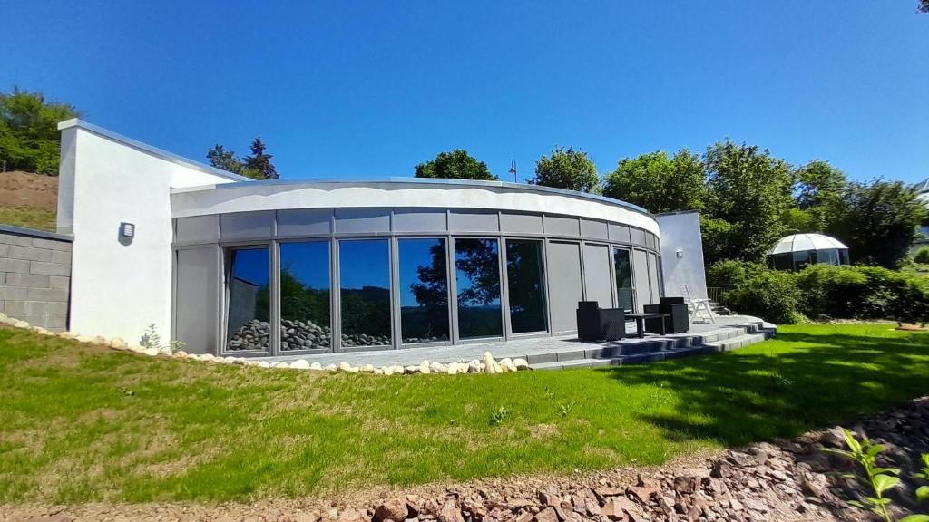a large white house with a large window at Bungalow Vulkanblick in Manderscheid