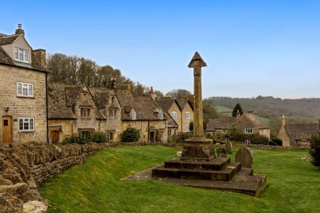 a village with a cross in the middle of it at Springhill Cottage in Snowshill
