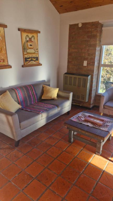 a living room with a couch and a coffee table at Cabañas Mateo in Villa Pehuenia