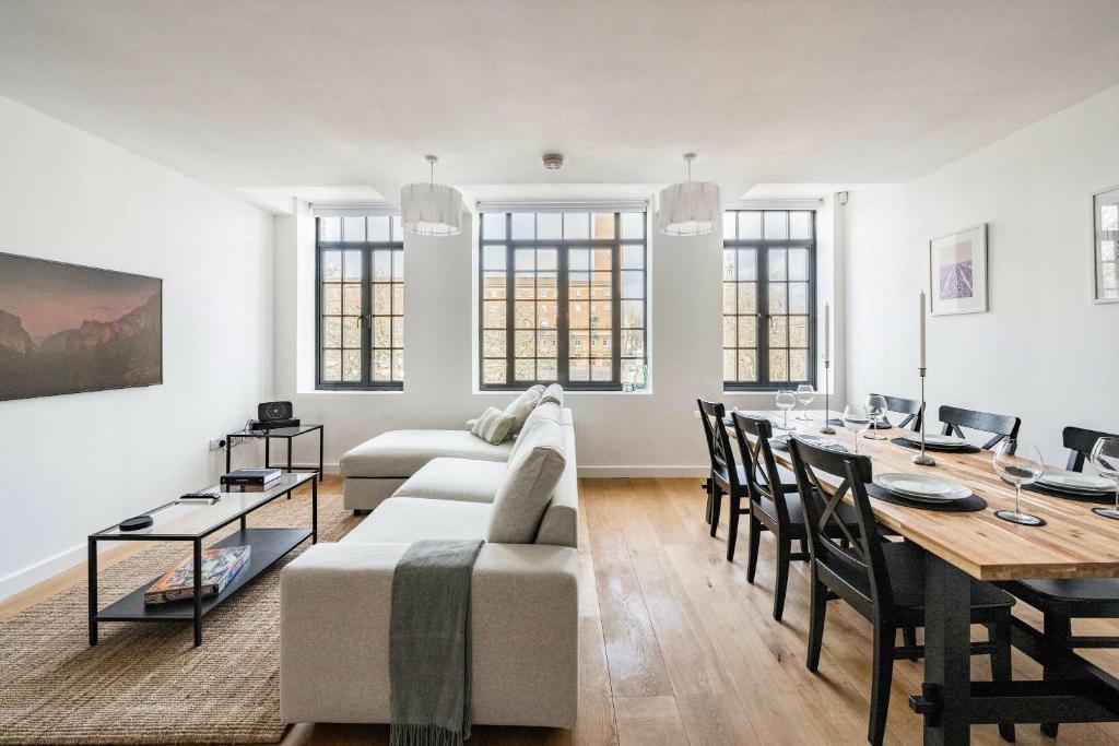 a living room with a couch and a dining room table at Seven Space - The Old Post Office Court in Norwich