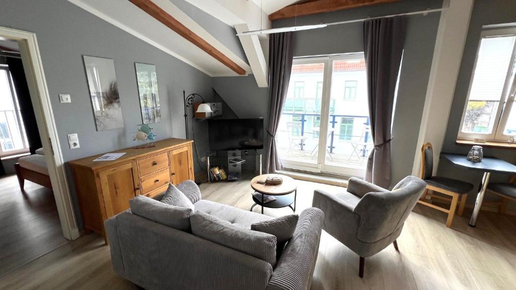a living room with a couch and chairs and a table at Apartments in Warnemuende in Warnemünde