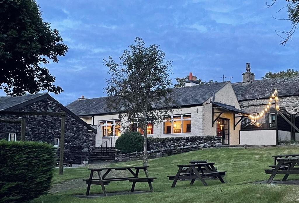 a group of picnic tables in front of a building at Cross Keys Inn in Penrith