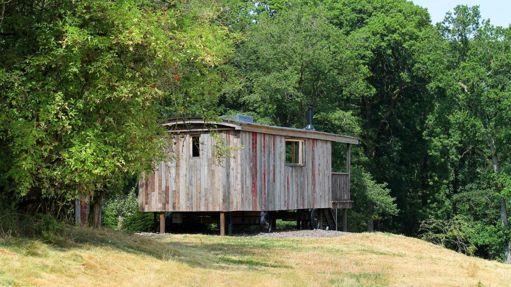 an old house on top of a hill at Bertha Shepherd's Hut in Lydney