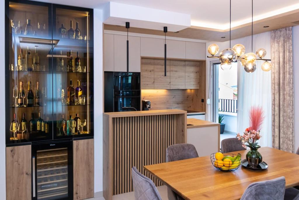 a kitchen and dining room with a dining table and a bar at Penthouse Petar in Kastel Stari